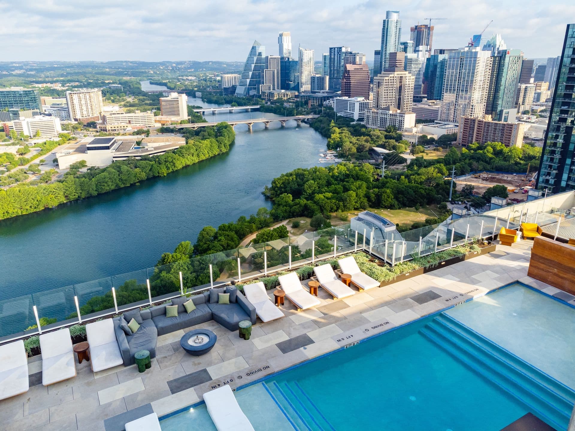 Aerial view of Austin Condo's rooftop pool & the city around it